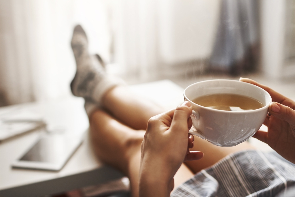 woman holding a cup of tea in the morning.